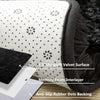 A close-up view of a black anti-slip rug mat featuring an ultrasoft velvet surface and memory foam interlayer.