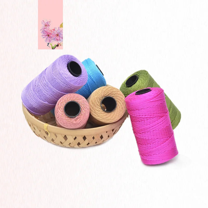 A collection of hand knitting and crochet cord in various colors including purple blue pink and green spools.