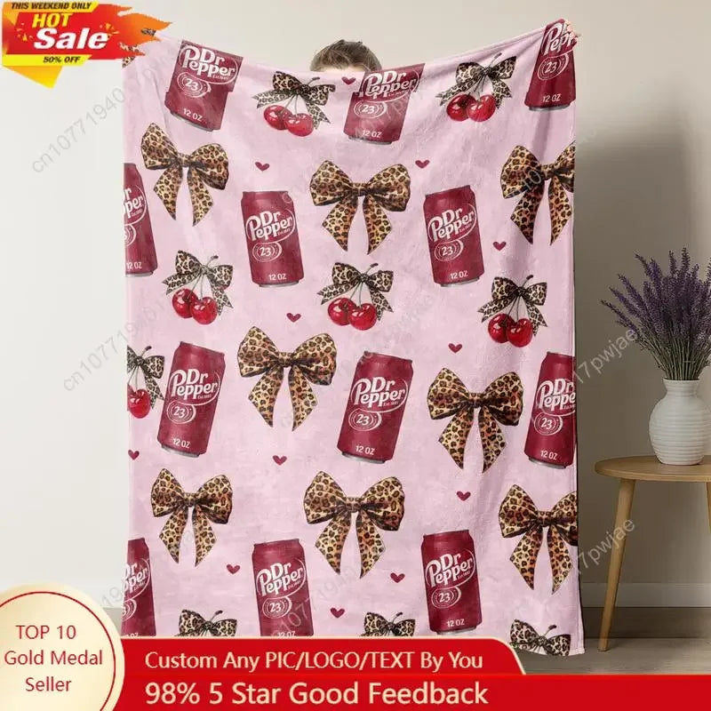 Pink flannel throw blanket featuring a leopard print pattern and decorative bows.
