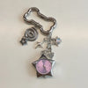 Silver star pocket watch keychain with an adjustable clock face and decorative charms