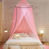 Pink sheer dome mosquito net draped over a bed, providing a mosquito-proof canopy.