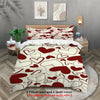 A red and white heart patterned duvet cover set displayed on a bed with framed art.