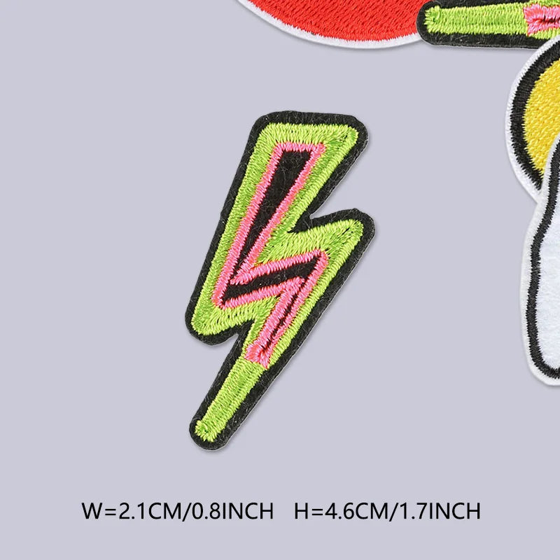 A close-up of a bright neon green lightning bolt embroidered patch on a gray background.