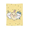 A yellow flannel throw blanket featuring three cute Chiikawa cartoon rabbits with small stars and squares scattered across th