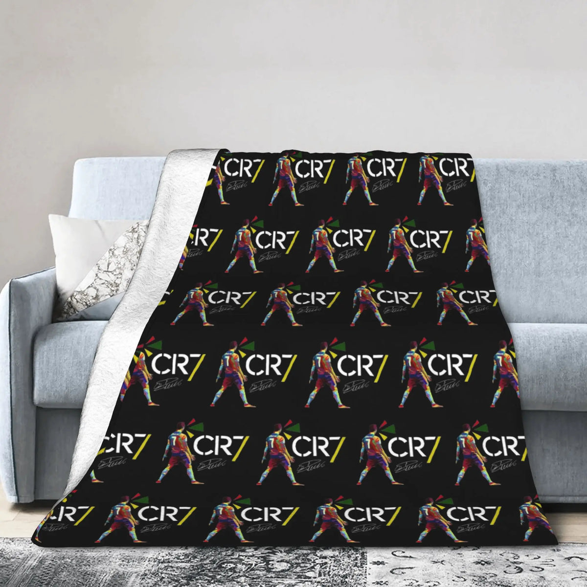 A black wool throw blanket featuring a repeating pattern of the text C7