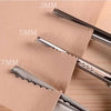 Close-up of professional dressmaking pinking shears with various blade sizes marked 3mm, 5mm, and 7mm on a beige paper backgr