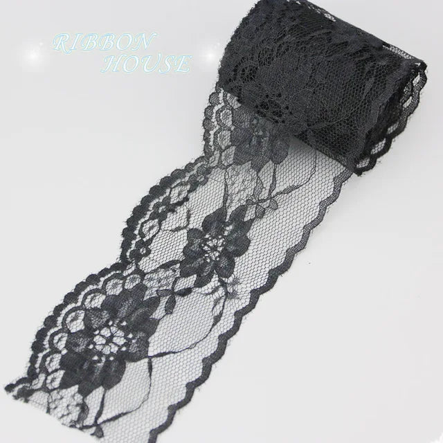 Black decorative lace ribbon roll with floral patterns and a black mesh band