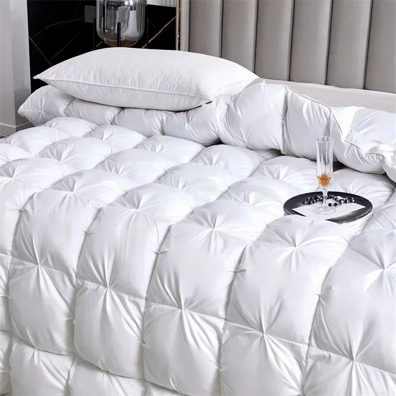 White quilted duvet with a fluffy pillow on a bed
