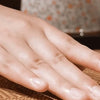 A hand rests on a natural bamboo cooling mat surface.