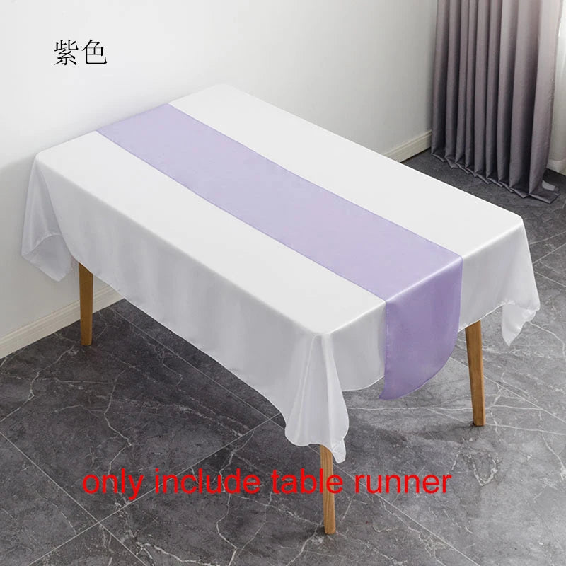 White satin table runner with a purple stripe displayed on a white tablecloth.