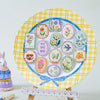 A colorful plate decorated with vintage botanical flower stickers and illustrations on a yellow plaid background.