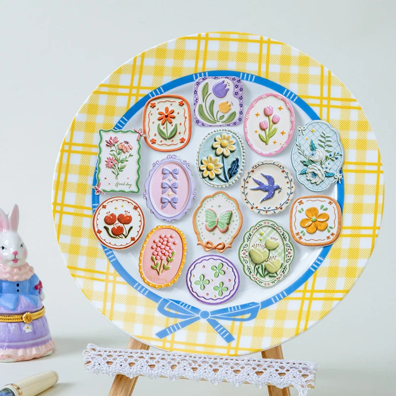 A colorful plate decorated with vintage botanical flower stickers and illustrations on a yellow plaid background.