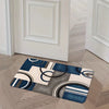 A rectangular geometric patchwork floor mat featuring blue, gray, and beige tones on a light wood floor.