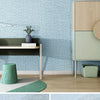 Light blue self-adhesive 3D thermal insulation wallpaper with a linen texture applied to a wall.