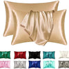 A collection of silky satin pillowcases in various shades including beige, pink, green, red, black, and blue.