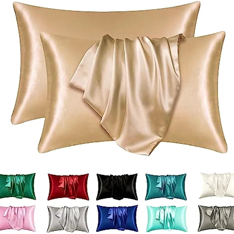 A collection of silky satin pillowcases in various shades including beige, pink, green, red, black, and blue.