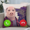 A decorative throw pillow featuring a cartoon pig face against a scenic landscape background.