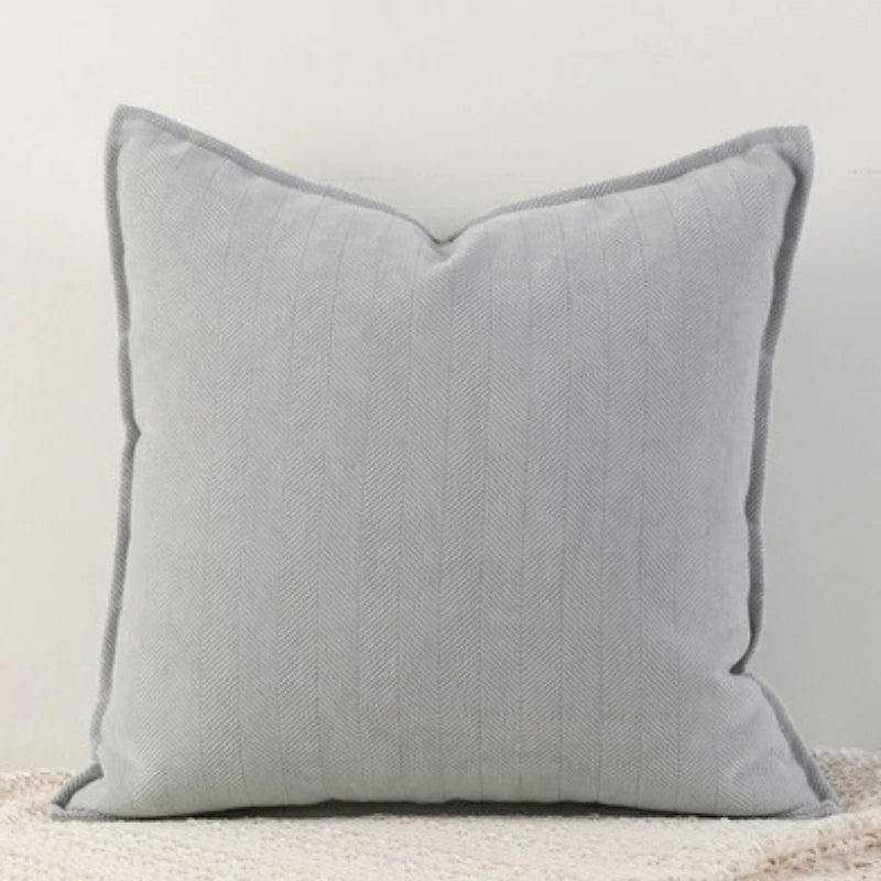 A light gray throw pillow cover with vertical stripes on a white background.