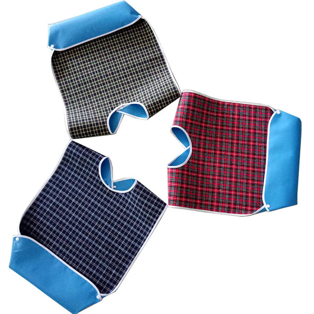 A set of adult waterproof mealtime bibs in blue and red plaid patterns.