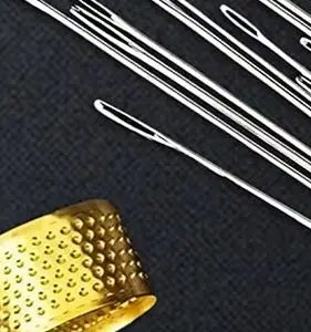 A close-up of precision stainless steel sewing needles and a gold-colored metal object on a dark background.