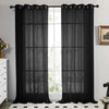Black sheer tulle window curtains hanging in a doorway with white trim and natural light.