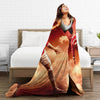 A woman is lying on a bed with a vintage football knit throw blanket featuring a football player in a red jersey.