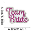Embroidered iron-on clothing patch with the text Team Bride in pink and gray thread.