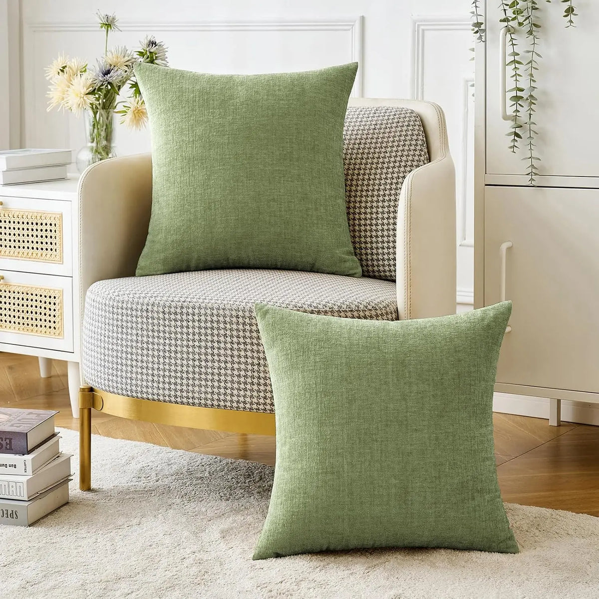 A solid green chenille throw pillow cover resting on a light-colored upholstered sofa.