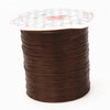 A cylindrical spool of multicolor elastic beading cord with a clear plastic cap.