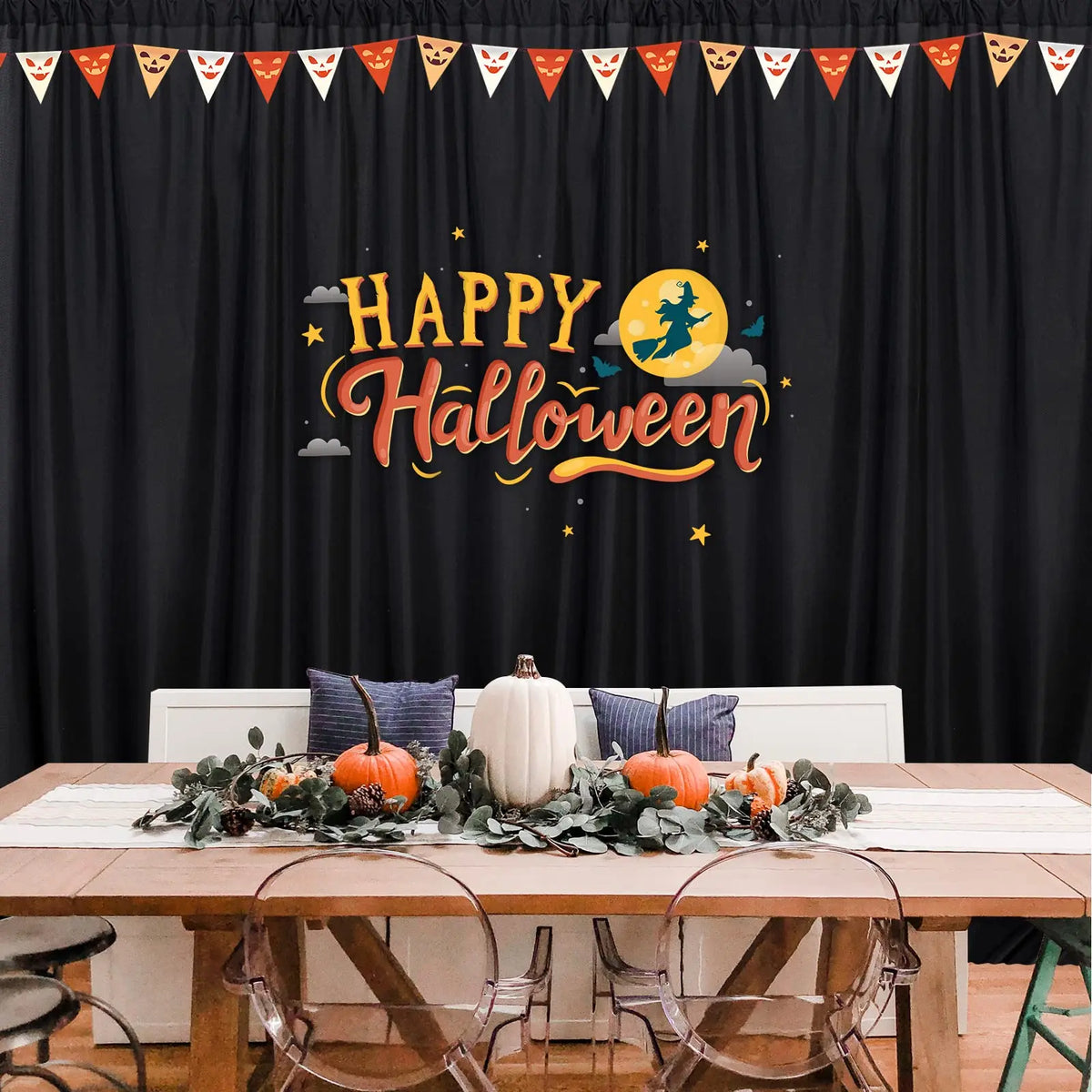 A black curtain panel decorated with a happy Halloween banner featuring yellow text and stars.