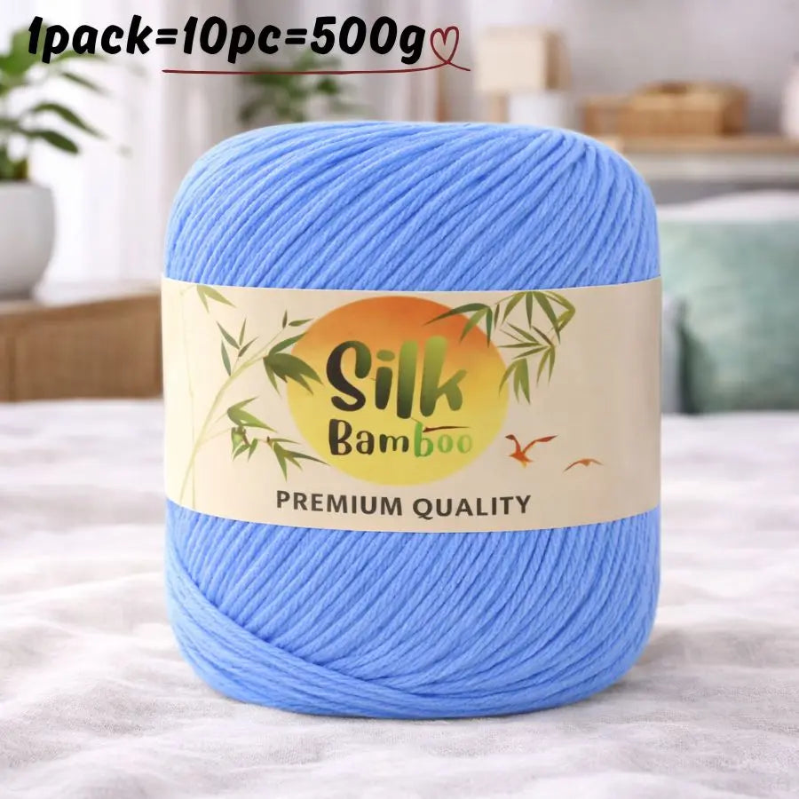 A skein of light blue silk bamboo blend yarn is shown on a white surface.