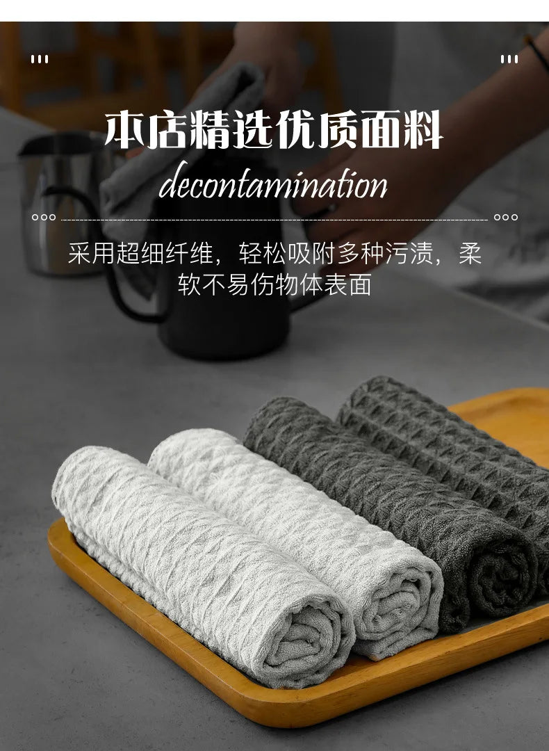 Rolls of gray lint-free microfiber cleaning towels displayed on a wooden tray.