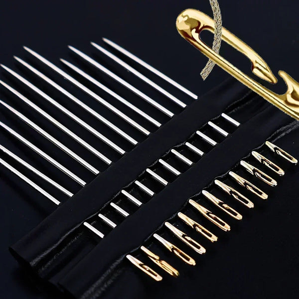 A close-up of a stainless steel sewing kit with various size needles and a gold-colored tool.