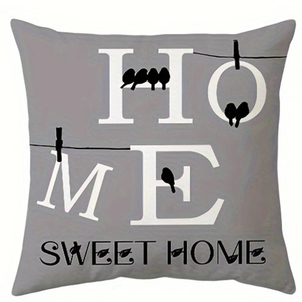 Gray pillow featuring the words HOME and SWEET HOME in white text with silhouettes of birds.