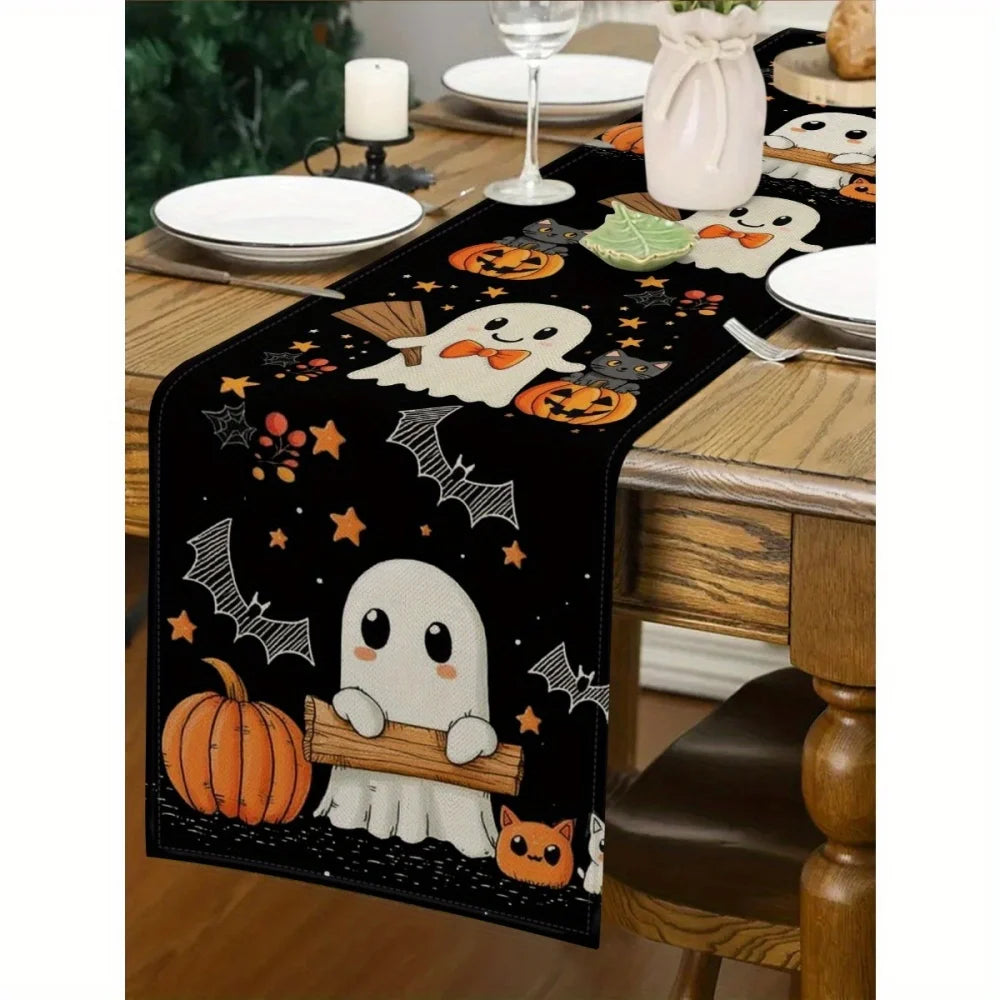 Black Halloween table runner featuring white ghost and pumpkin designs on a wooden table.