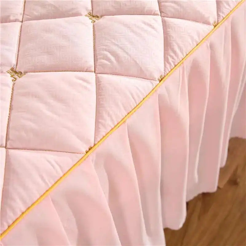 Pink embroidered quilted bed skirt with gold trim