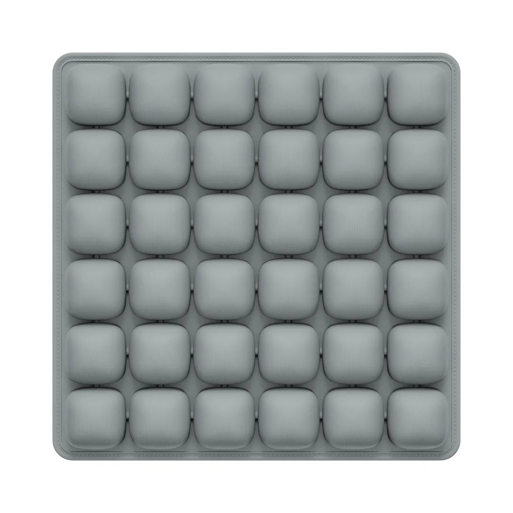 A gray seat cushion with multiple square pockets for an adjustable press-to-inflate design.
