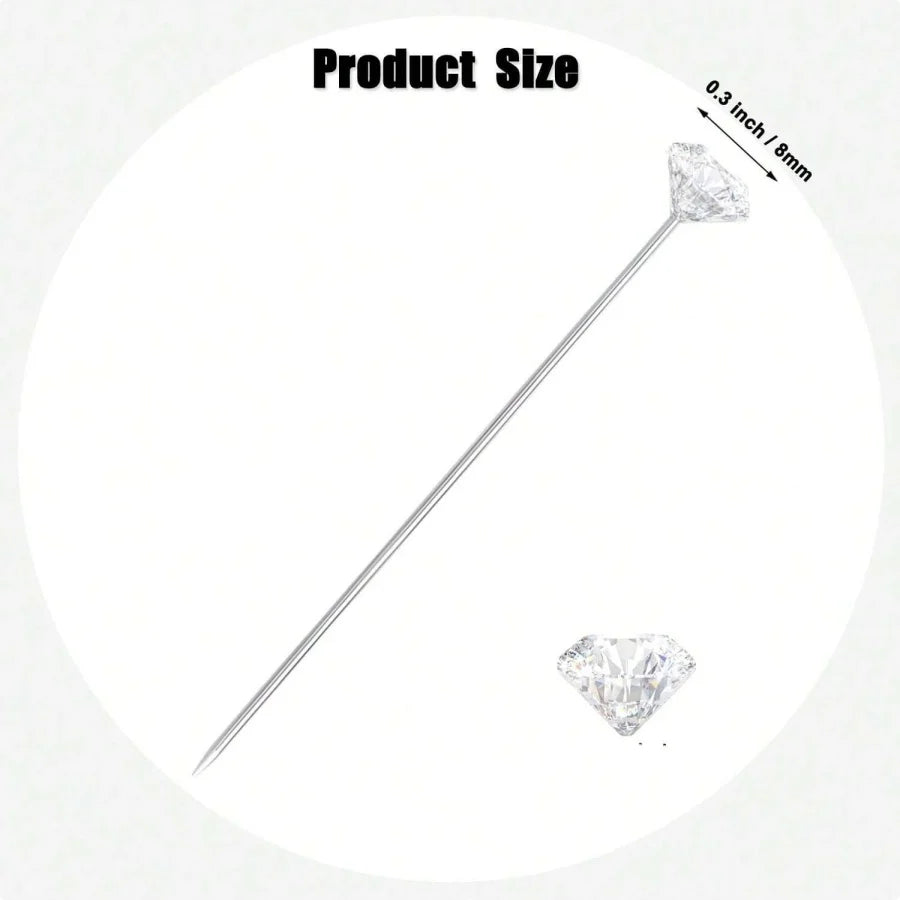 A silver diamond pin with a pointed tip is shown next to a loose clear diamond.