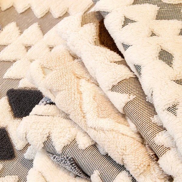 Close-up of a beige and gray patterned fleece fabric used for a sofa slipcover.