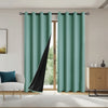 A pair of teal curtains with black panels hanging in a modern living room window.