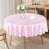 A round table covered with a pink satin overlay cloth set for dining.