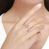 A close-up of a hand wearing a silver adjustable crochet loop ring on the finger.