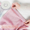 A hand is shown applying fusing tapes to bond two layers of pink fabric.