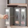 A hand opens a gray non-woven fabric storage box designed for bedding and clothing.