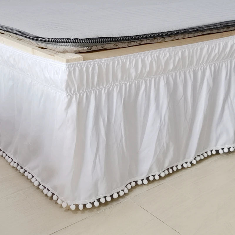 White elegant elastic bed skirt with a gathered hem and decorative pearl trim