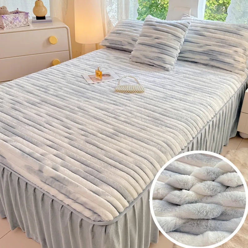 A plush bed skirt linen set featuring gray and white striped bedding on a bed.
