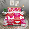 A pink and red heart patterned comforter set with two pillowcases and a quilt cover displayed on a bed.