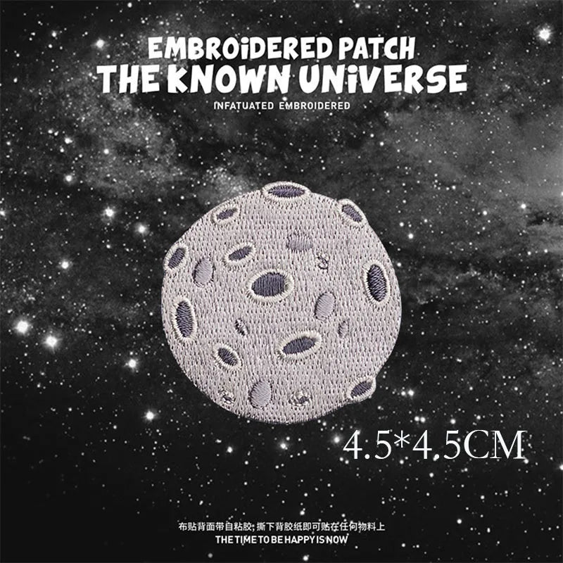 Embroidered patch featuring a textured, gray celestial body against a dark starry background.