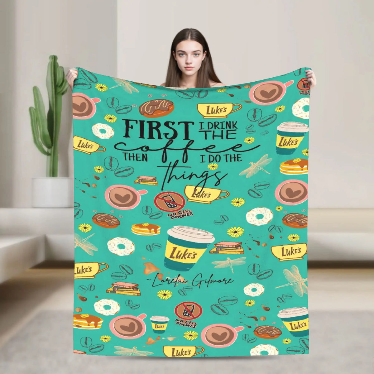 A teal throw blanket featuring a repeating pattern of coffee cups and food items with the text First I Drink the Coffee Then 