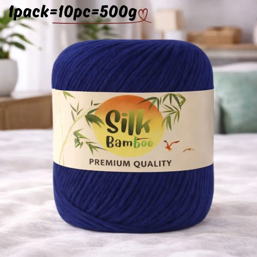 A skein of dark blue silk bamboo blend yarn labeled premium quality on a white background.